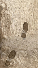 Beach foam with footprints