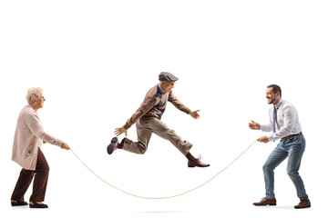 Elderly mother and son holding a rope and senior man skipping