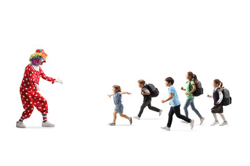 Group of children running towards a clown