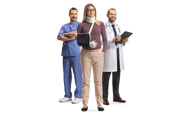 Injured woman with an arm sling standing in front of male health care workers