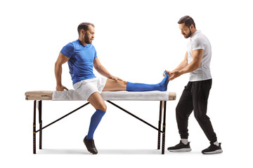 Obraz premium Physical therapist checking the foot of a football player