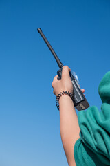 hand of a person holding an airband transceiver