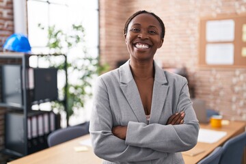 African american woman at the office happy face smiling with crossed arms looking at the camera. positive person.