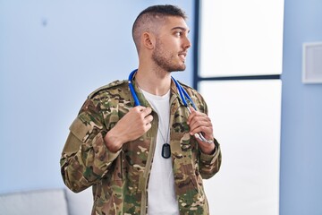 Fototapeta premium Young hispanic man army soldier doctor holding stethoscope at home