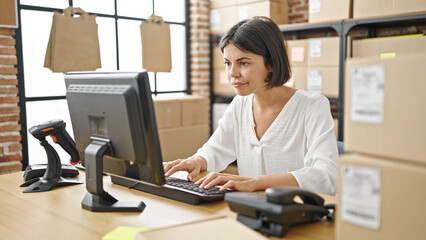 Young beautiful hispanic woman ecommerce business worker using computer at office