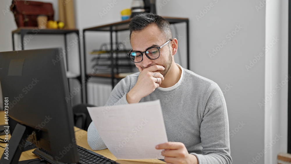 Canvas Prints Hispanic man business worker reading document at office