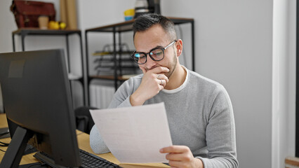 Hispanic man business worker reading document at office