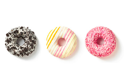 Three sweet donuts in colored glaze top view on a white background