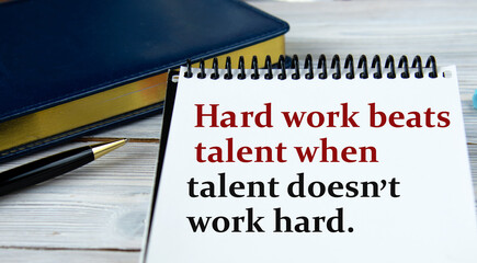 Hard work beats talent when talent doesn't work hard - word in a notebook on the background of a...