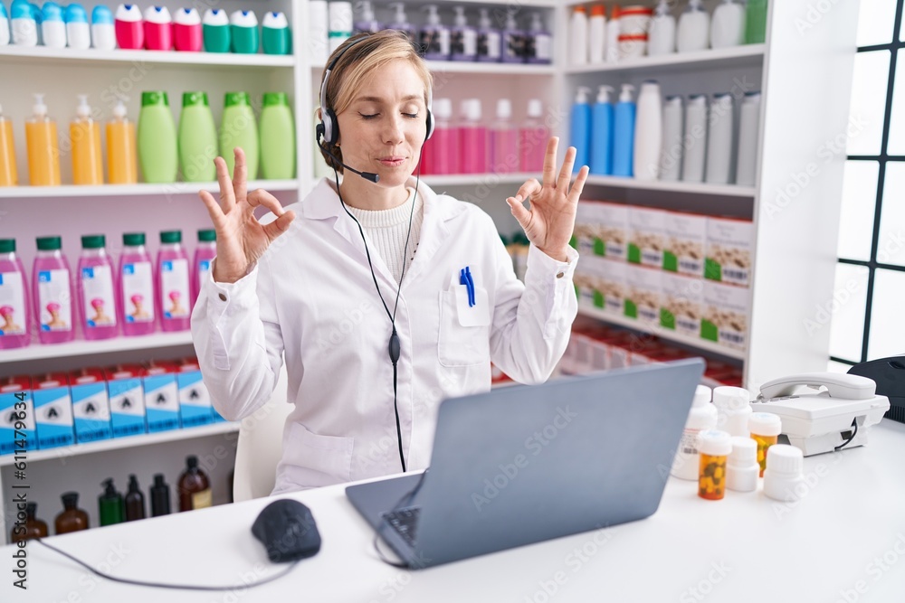 Sticker young caucasian woman working at pharmacy drugstore using laptop relax and smiling with eyes closed 