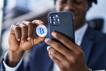 African american man business worker make photo by the smartphone to bitcoin at office