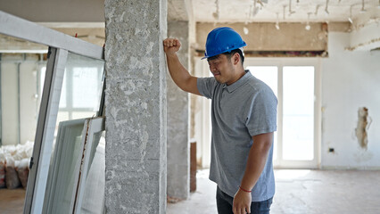 Obraz na płótnie Canvas architect hitting wall at construction site