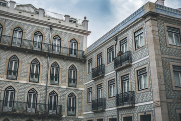 Fototapeta na wymiar Classic apartment building with balconies and pattern on the walls in Lisbon, Portugal
