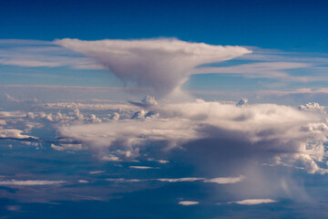 Obraz premium Aerial photograph of clouds outside of my airplane window on a cross country plane trip from Chicago to Los Angeles during the summer
