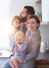 Young family with daughter and son in the kitchen