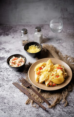 Conchiglie pasta with minced chicken, red pepper and ricotta cheese in a plate
