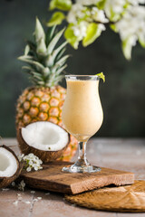 Pina colada pineapple cocktail or Lassi on a rustic wooden table