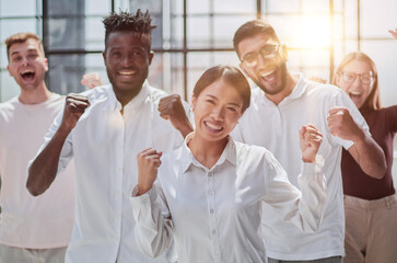 Portrait of creative business team standing together and laughing. Multiracial business people together