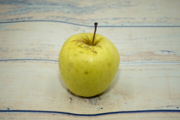 Green apples on a wooden floor