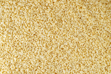 Vanilla flavored rice, corn and wheat cereal background. Crispy puffed yellow  rice. Delicious and...