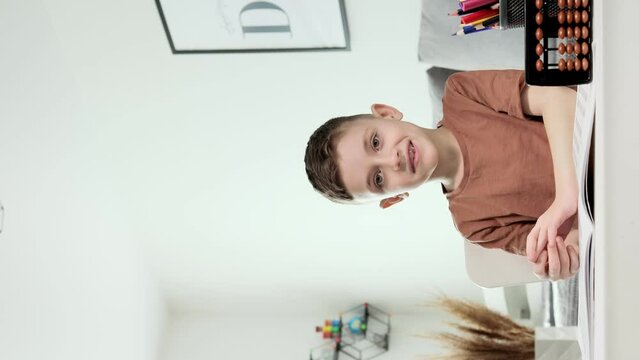 Little preschooler counting large numbers on his fingers using mental arithmetic, concept of child development.