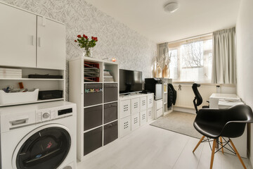 a laundry room with washer, dryer and washing machine on the floor in front of the window there is a wallpaper