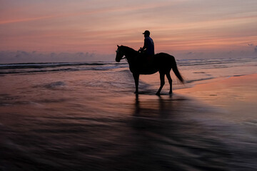 long exposure, silhouette in sunset parangtritis  Yogyakarta, Indonesia