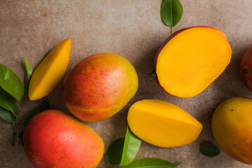 Mango background design concept. Top view of  fresh mango fruit pattern with leaves on  table.