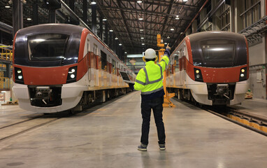 Obraz premium Railway engineer standing in depot and railway inspection. construction worker on railways. Engineer work on railway. rail, engineer, Infrastructure