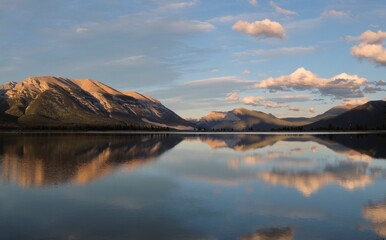 Peaceful mountain lake with reflections in sunset. Kananaskis lake near Canmore. Canadian Rockies.  Alberta. Canada