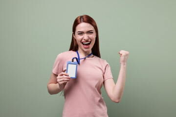 Emotional woman with vip pass badge on pale green background
