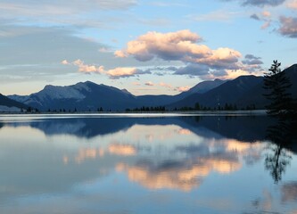 Peaceful mountain lake with reflections in sunset. Kananaskis lake near Canmore. Canadian Rockies.  Alberta. Canada