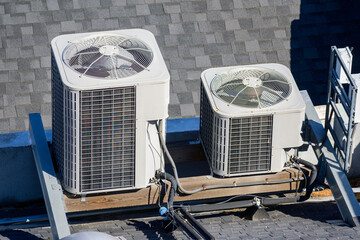 Two air conditioner units HVAC on a roof of industrial building
