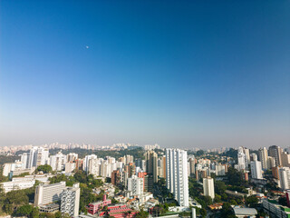 Fototapeta premium 2023 view of the Pinheiros river with modern buildings beside it and the famous Octavio Frias de Oliveira bridge in the city of São Paulo.