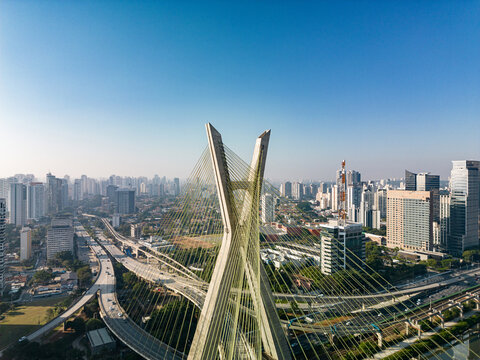 2023 view of the Pinheiros river with modern buildings beside it and the famous Octavio Frias de Oliveira bridge in the city of S&atilde;o Paulo.