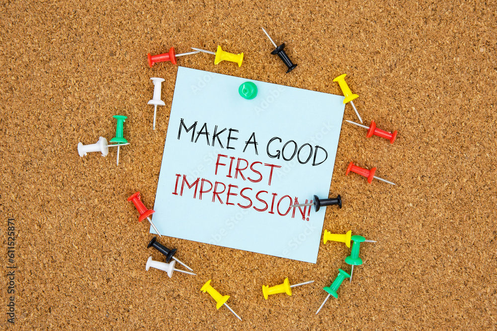 Poster make a good first impression text on light blue post-it paper pinned on bulletin cork board surround