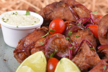 fried chicken with tomatoes and caramelized onions wings with herb sauce