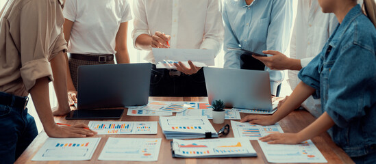 Analyst team utilizing BI Fintech to analyze and pointing at financial dashboard paper office....