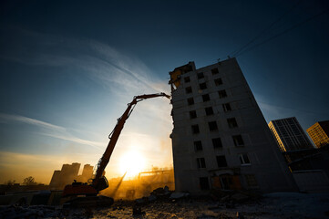 Demolition of residential building with crawler excavator