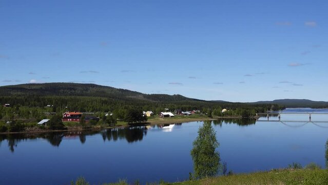 Vindeln, Sweden A summer landscape and steel car bridge crossing the Pitea River on a sunny day.