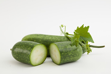 Advertising photo for product with winter melon ingredient - winter melon cut in half and green leaf arranged on a white background. Winter melon is one of the popular foods in daily meals in Vietnam
