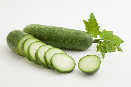 Winter melon known as wax gourd or ash gourd cut into slices and leaf decorated on a white background. Winter melon contains a high amount of vegetable oil, which is very beneficial for skin and hair