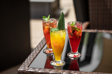 Glasses of fresh fruit assorted lemonades on cafe table