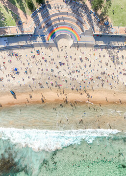 Aerial Top-Down View of Coogee Beach Rainbow Walkway with Crowded Shoreline and Turquoise Ocean Waves, Sydney