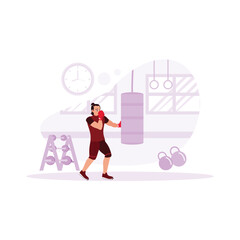 Male boxer, enthusiastically punching a punching bag in front of him in a modern gym complete with sports facilities and a wall clock to indicate the time. Trend Modern vector flat illustration.