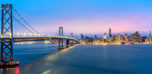 Cityscape view of San Francisco and the Bay Bridge with Colorful Sunset from island