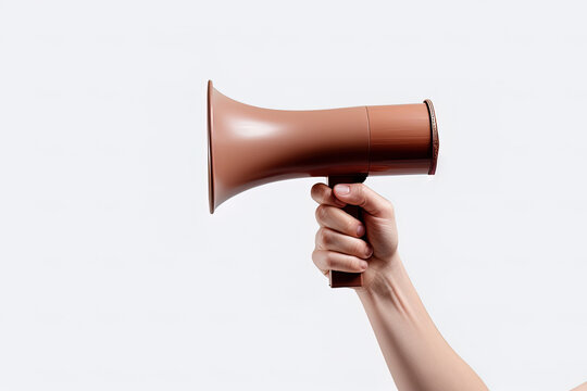 The hand holds a brown megaphone on a white background. Announcement concept. Shout It Out