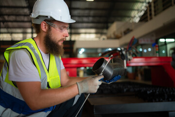 A mechanical engineer measuring product dimensions of new machinery installed