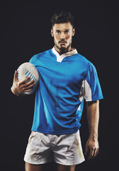 Rugby, black background and portrait of man athlete with ball in dark studio while training in dirt...