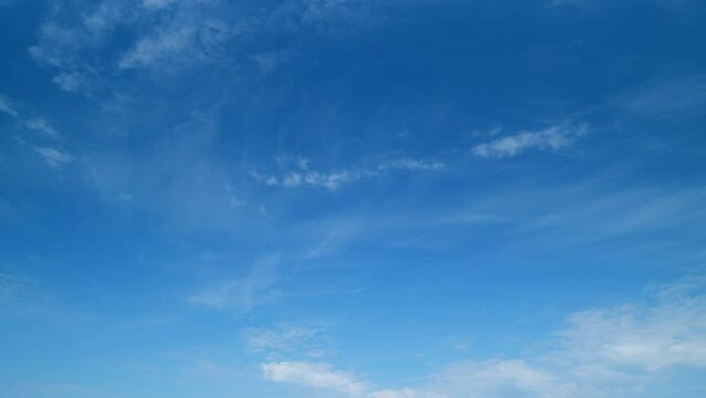 Blue sky with cirrus clouds and sun. Beautiful sky with clouds background. Timelapse.